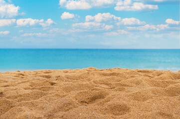 Fototapeta na wymiar Close-up sand beach with sea and cloud on blue sky background