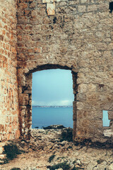 Sea view through the ruins of an ancient fortress