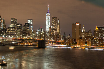 Panoramic View on Manhattan Skyline and Brooklyn Bridge at Night 