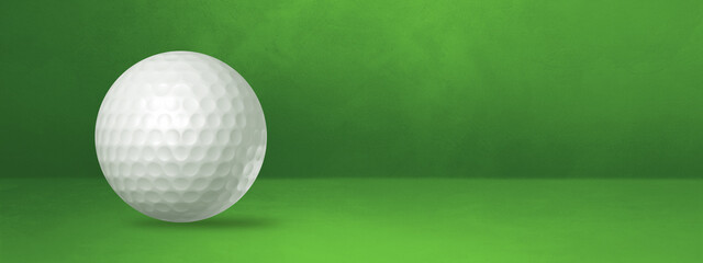 White golf ball on a green studio banner
