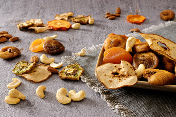Plate with variety of dry fruits and nuts healthy snacks.