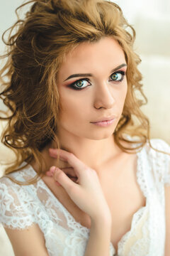 Young girl bride with makeup and hairstyle. Wedding morning.