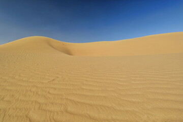 Fototapeta na wymiar Wind-shaped hollow and pyramidal sand peak.. Badain Jaran Desert-Inner Mongolia-China-1210