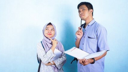Asian muslim woman and man are discussing and studying together. Asian student preparing for final examination.