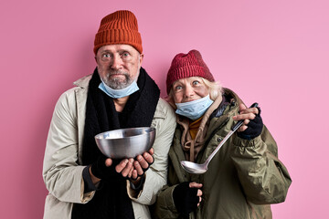 elderly beggars man and woman ask food donation, holding iron bowl in hands, need food for surviving