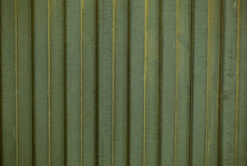 Background texture of decorative fluted green cladding in a repeat vertical pattern in a full frame view. This is a lighter version, a darker version is also available in the portfolio