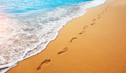 footprints on  tropical beach and beautiful  wave - 404947365