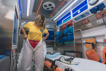 young sanitary woman puts on a protective suit against viruses