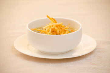 SOUP WITH FRENCH FRIES IN PLATE AND WARM BACKGROUND