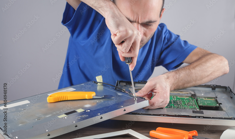 Wall mural electrician engineer repairing computer monitor.