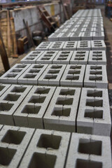 Industrial production of building materials from pressed cement mortar. High quality hollow concrete block or cement brick.