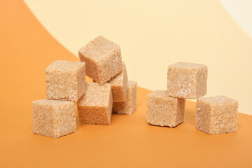 cane sugar cubes on brown background, trend color place copy, roll paper, beige background