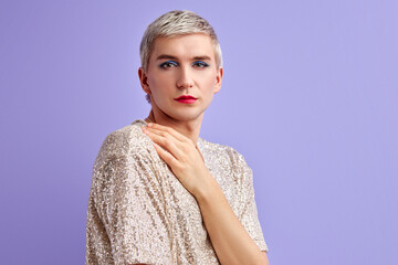transgender looks at camera, posing isolated in studio. portrait of male model wearing make-up