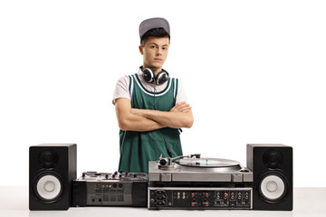 Young male dj with vinyl turntable posing with crossed arms