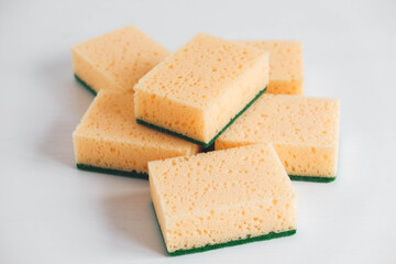 Yellow porous sponges on a white background. Copy, empty space for text