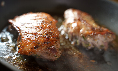 Duck fillet is cooked in a pan.