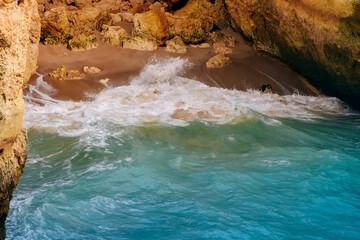 .Rock by the sea. the concept of harmony, energy of life and meditation. benagil in portugal, cliffs on the famous beach , waves crashing on cliffs, the raging ocean.