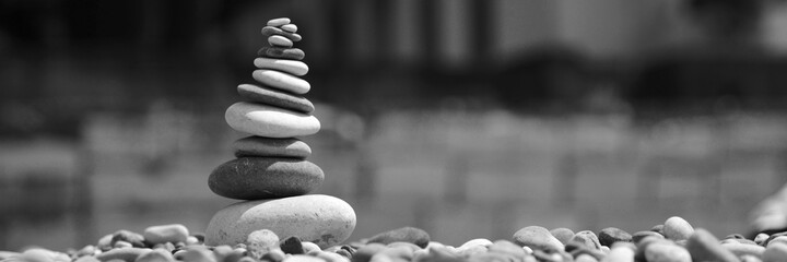 a stone tower stands on the beach in black and white