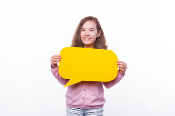 Smiling cute young girl holding yellow speech bubble.