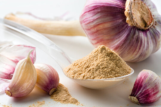 garlic powder on white table with spoon
