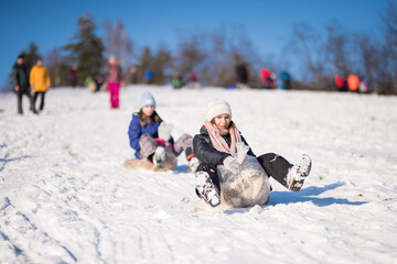 Fototapeta na wymiar Happiness on snow. Two girl having fun on snow. 