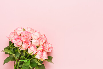 Pink roses bouquet on a pink background. Valentines Day, Mothers Day, and Birthday celebration concept.