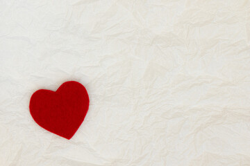 Fototapeta na wymiar Red decorative heart on white paper background.