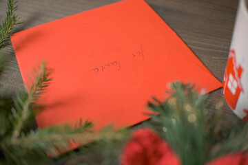 Christmas red envelope with Christmas decorations on a wooden table