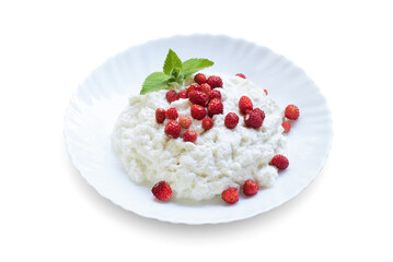 Plate with cottage cheese, wild strawberries and mint on a white background