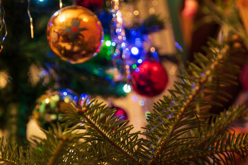 coniferous sprig christmas tree ornaments in background