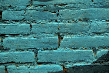 Painted blue brick wall background texture and pattern with repeat rows of long rectangular bricks in a full frame view. This is a lighter version, a darker version is also available in the portfolio