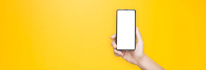 concept - cell phone in a man's hand on yellow background