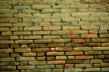 Old weathered clay brick background texture with eroded masonry exposing the bricks in a full frame view. This is a lighter version, a darker version is also available in the portfolio