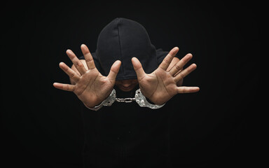 Handcuffed hand of a prisoner in prison, dangerous criminal punished by law
