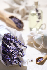 Close-up on dry lavender flowers in white tracing paper. Hand made lavender sachets on cotton...