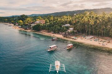 AERIAL VIEW OF PHILIPPINES BEACH WITH TRADITIONAL BOATS OH THE SHORE