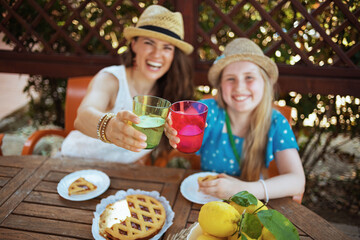 Smiling family clinking glasses and having lunch