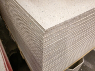 Gypsum Fiber Boards in the warehouse. Construction material for indoor work. Selected focus