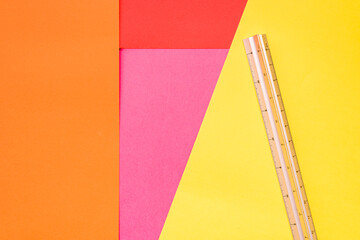 Cardboards sheets of various colors, a ruler to measure them and make crafts.