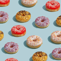 Fototapeta na wymiar paterna of mouthwatery fresh doughnuts on a blue background