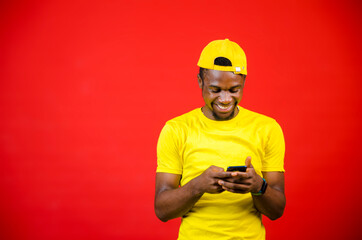 a young african boy feeling excited as he operate his cellphone