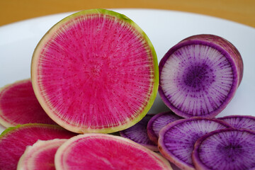 Obraz na płótnie Canvas Slices of green and pink watermelon (red meat) radish and purple Blue Meat radish