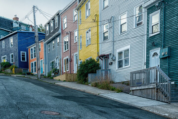 St. John's, NL Canada-January 2021:A row of colourful wooden houses on a small narrow street in St. John's, Newfoundland with snow flurries coming down at the start of a large winter storm.