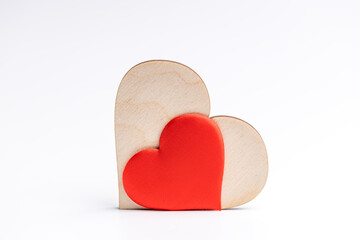 couple hearts red one and wooden over white background. love and romance concept. valentine day greeting card conceptual