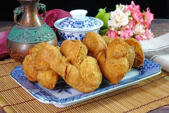 Deep fried dough fritters or "Khanom Si Kha" , the most famous Phuket Breakfast and dessert in Phuket Vegetarian festival. Selective focus