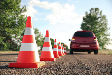 Traffic cones near car outdoors. Driving school exam