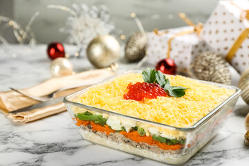 Traditional russian salad Mimosa and festive decor on white marble table