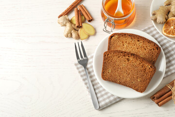 Fresh gingerbread cake slices served on white wooden table, flat lay. Space for text