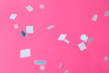 Fototapeta na wymiar Grey confetti falling down on pink background