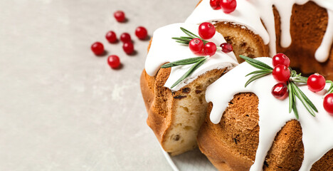 Traditional homemade Christmas cake on light grey table, closeup view with space for text. Banner design